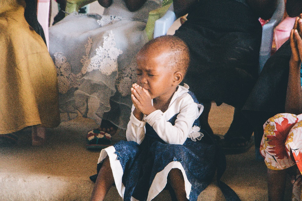 Bald child praying